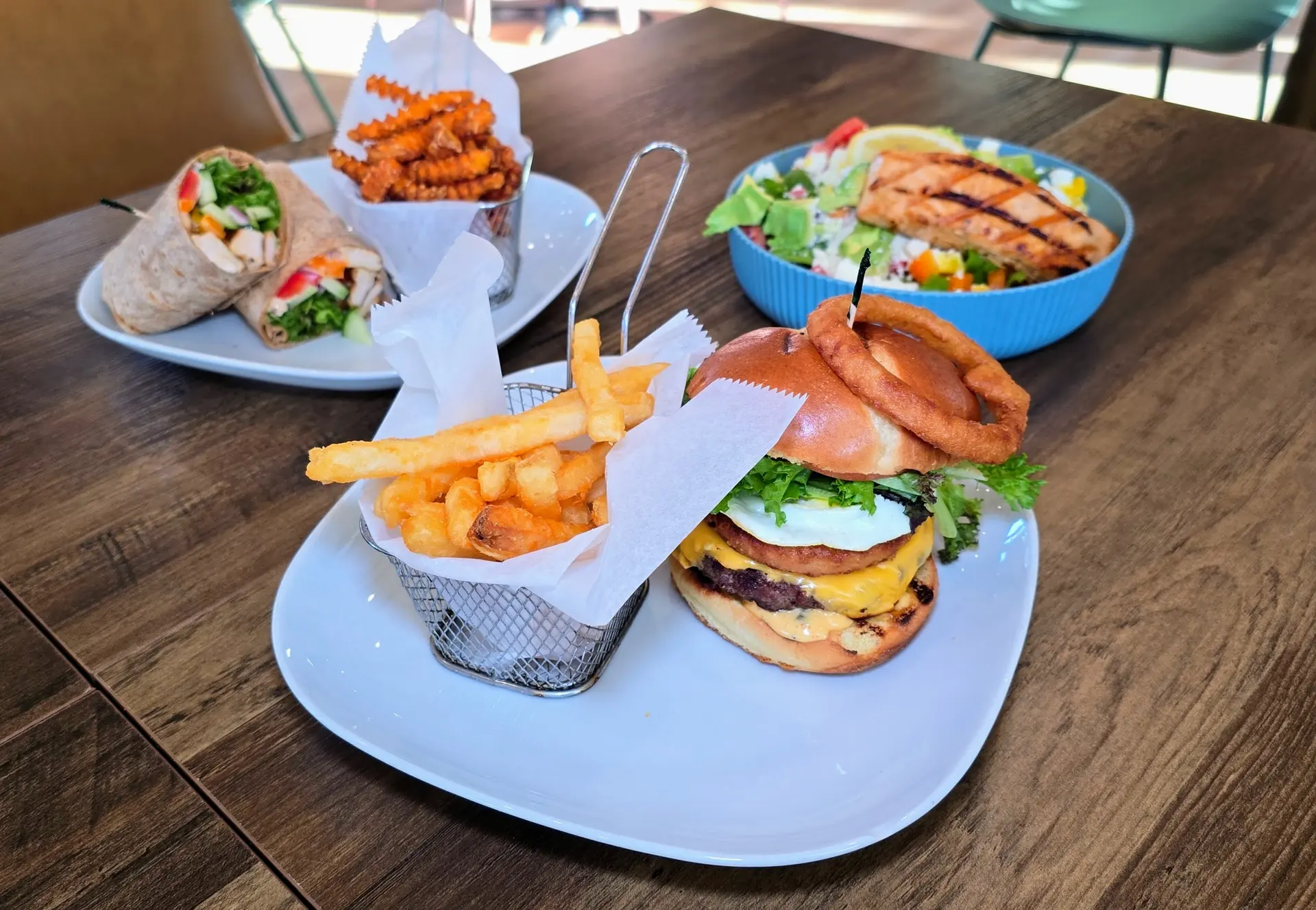 Burger, fries, wrap and salad at The Padel Grille